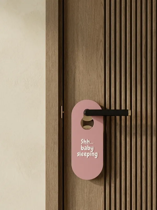 Pink door hanger reading Shh... baby sleeping, made in the Door Hangers generator.