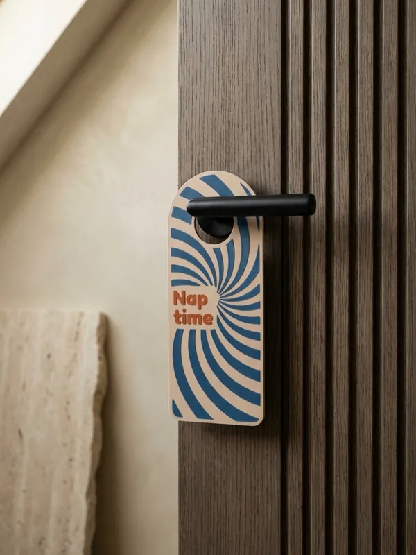 Arched door hanger with the text and a swirl pattern in two colours.