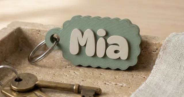 Sage green name keychain reading Mia, made in the Keychains generator.